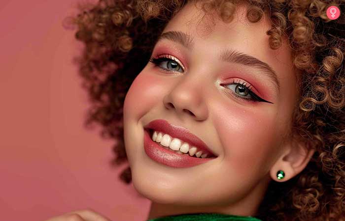 Model with dramatic pink and green eye makeup on
