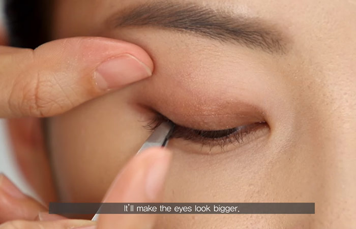 Step 7 of hooded eye makeup is to use false lashes