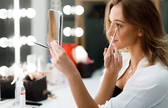 A woman doing her makeup
