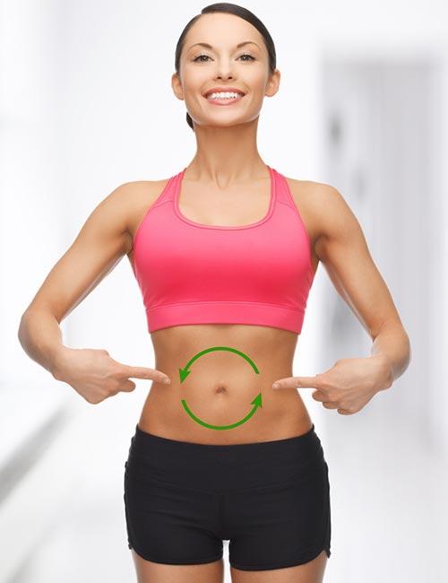 Woman with one hand on belly to portray good digestive health