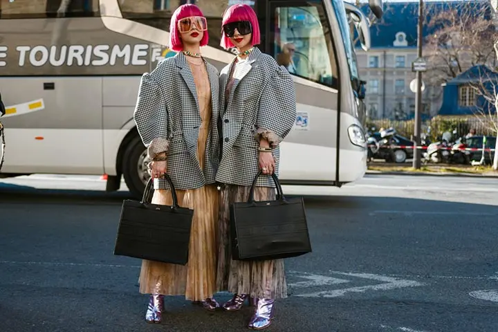 Japanese fashion models posing outside an event venue