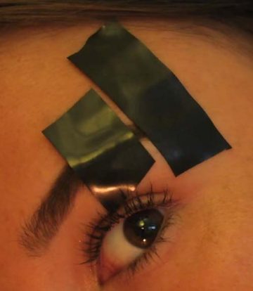 Place tapes parallel to eyebrow line to do eyebrow slits