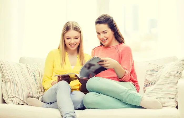 Two women reading their horoscopes