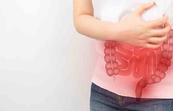 Woman holding her stomach due to a gastrointestinal disorder