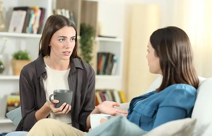 Two friends sitting and talking over a cup of coffee