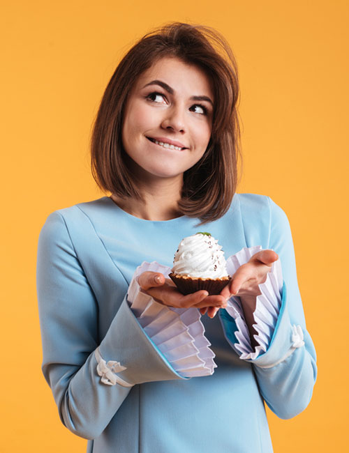 Woman holding a cupcake