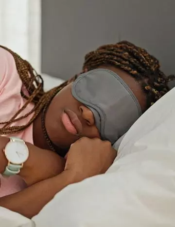 A woman sleeping with braids