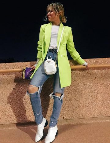 Distressed jeans and neon trench coat as a hipster outfit idea