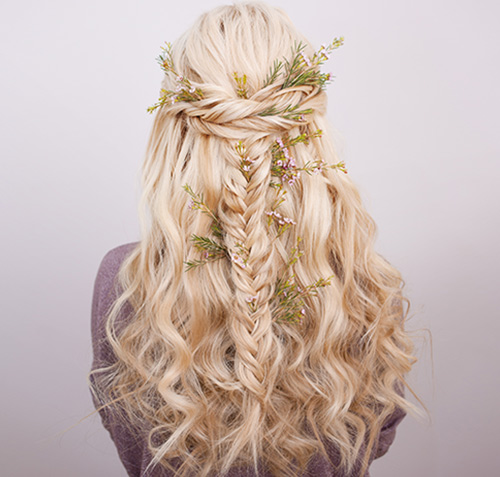 Blonde curly hair in boho crown braid