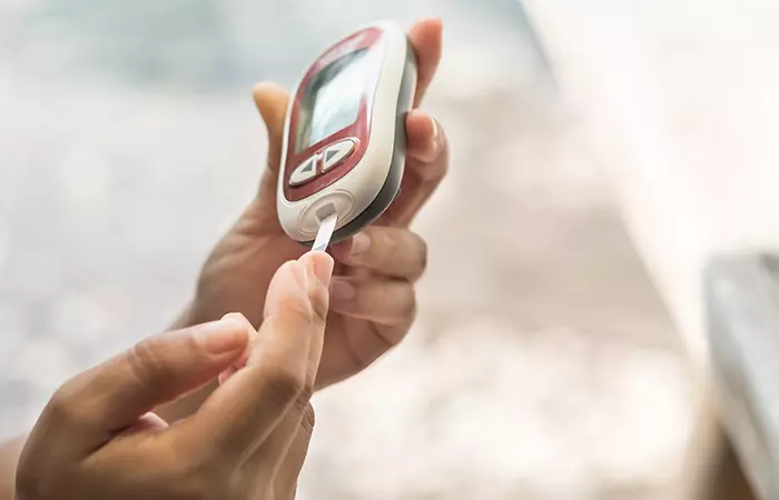Man checking blood sugar level