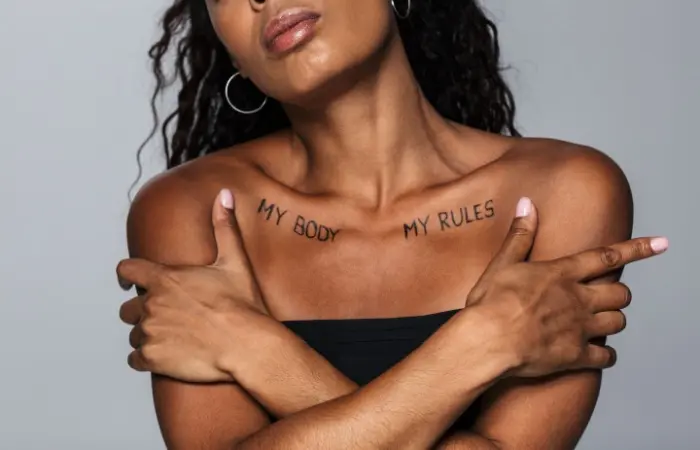 A woman with My Body, My Rules written on her body