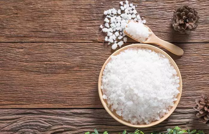 Epsom salt in a wooden cup for a therapeutic bath to manage edema