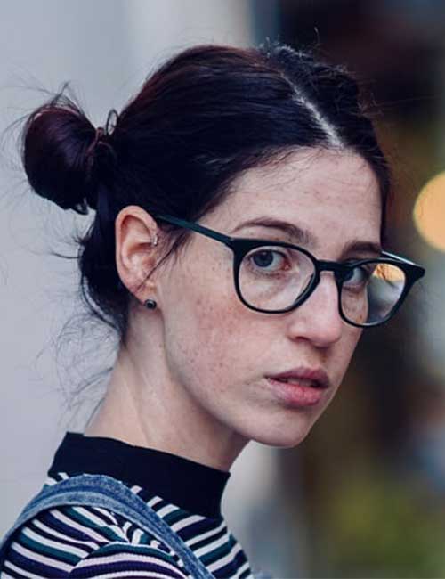 Messy low buns hairstyle for women with glasses