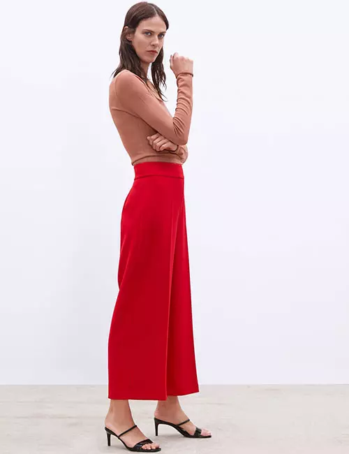 Red culottes and tan sweater