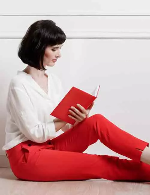 Young woman wearing red pants and white shirt