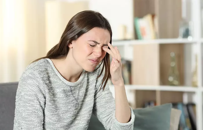 Woman with irritated eyes after using cedarwood essential oil 