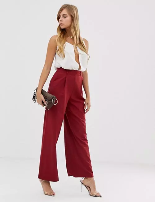 Wide legged red trousers and white pleated top
