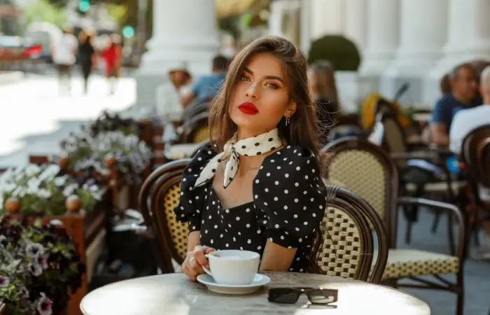 A woman wearing polka dot dress with scarf