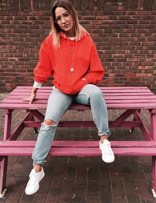 Distressed gray denim with red hoodie and white sneakers for tomboys