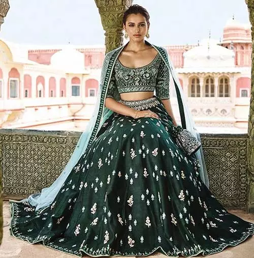 An emerald green lehenga with gotta patti work for reception for Indian brides