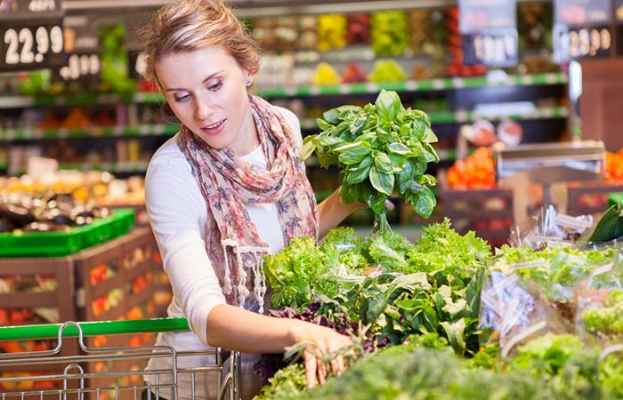 Woman buying fresh vegetables