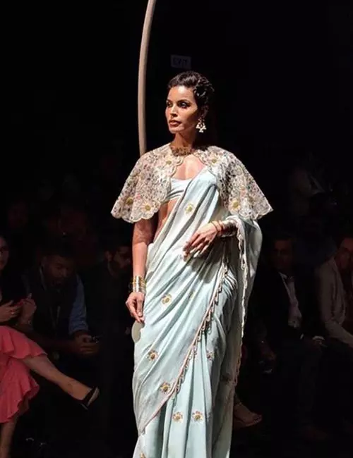 A powder blue saree and cape blouse for reception for Indian brides