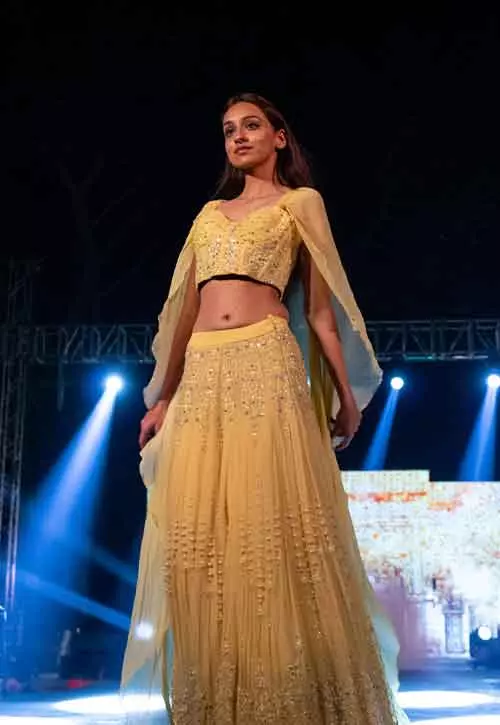 A yellow embroidered net lehenga in yellow for reception for Indian brides