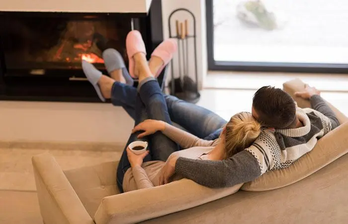 young-romantic-couple-sitting-on-sofa