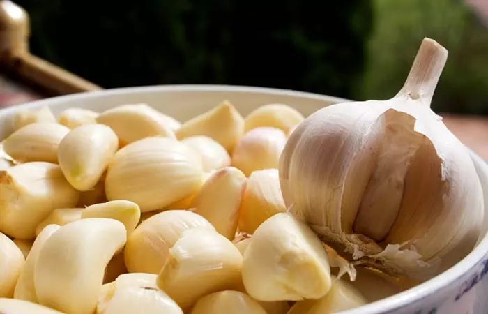 Cloves of garlic on a wooden tray