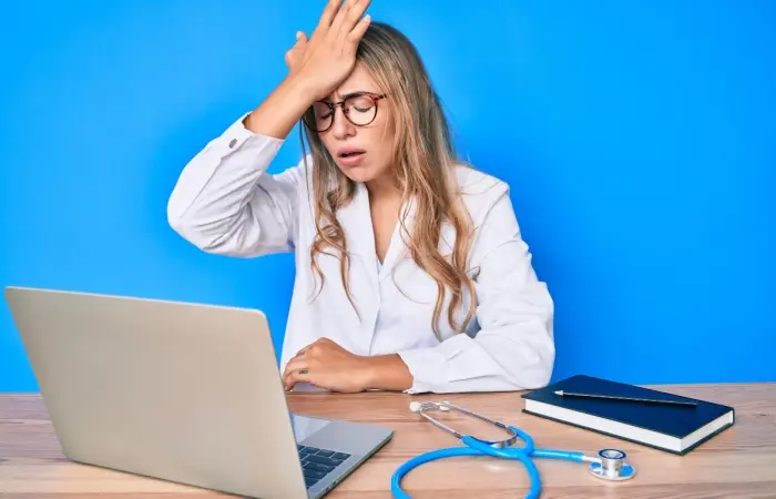 A surprised doctor looking at her laptop