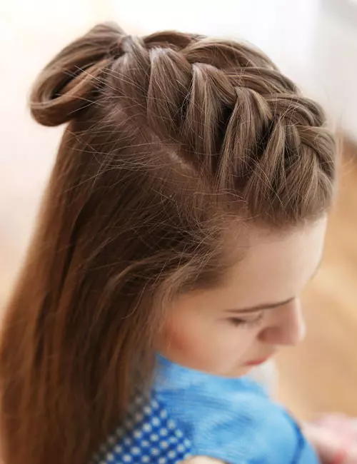 A young woman sporting a half-up French braid