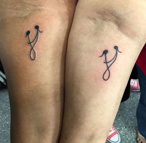 Matching symbol tattoos for mother and daughter