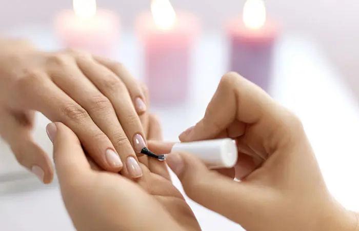 A woman applying nail polish