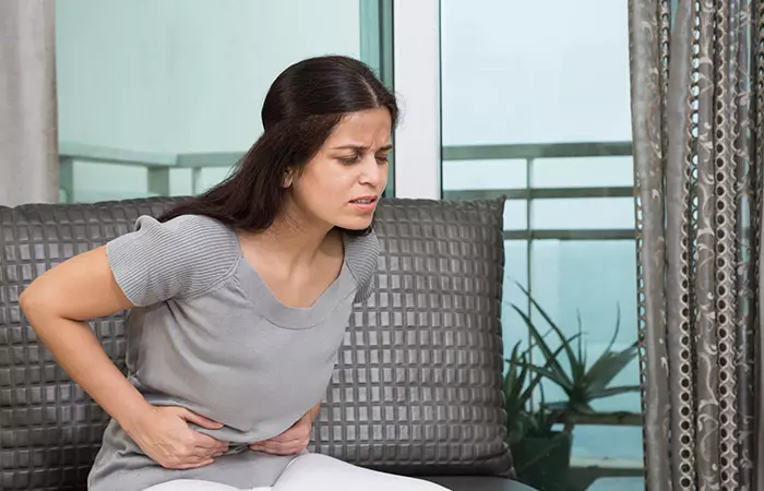 Happy woman with good digestion, a benefit of having jaggery