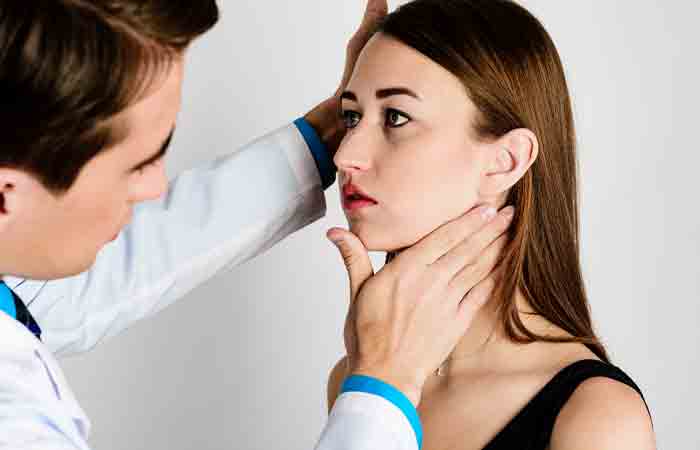 Doctor checking a woman's jaw before V-line surgery.