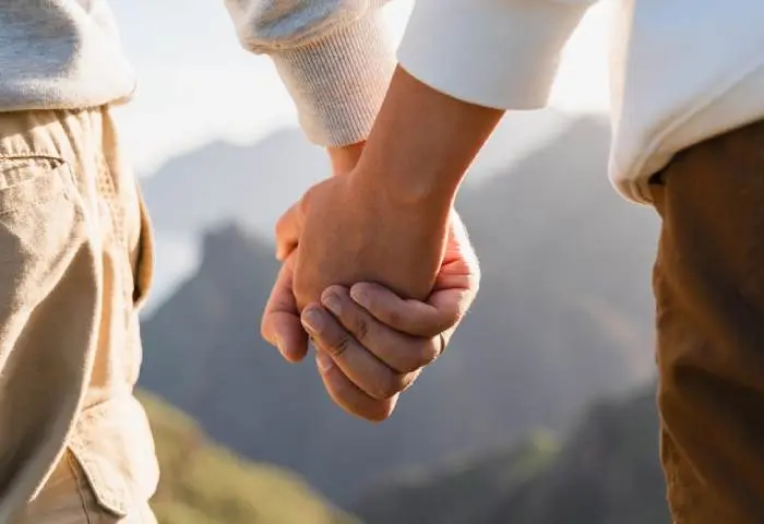 A happy couple holding hands.