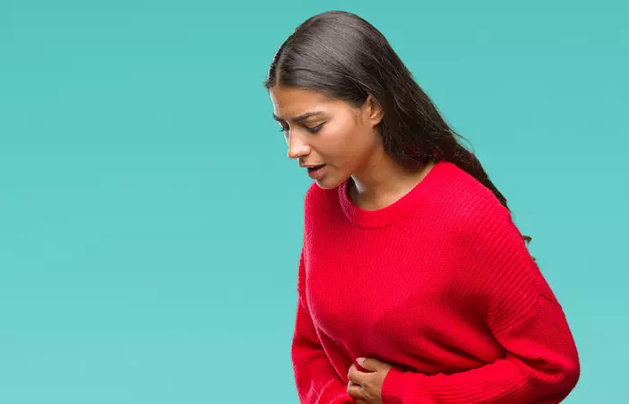 Woman feeling nauseaous due to excess consumption of almonds