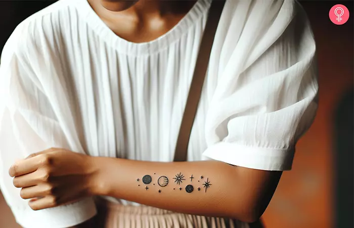 A woman with a minimalist black space forearm tattoo