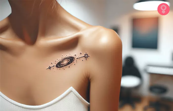 A woman with a minimalist space tattoo on her upper chest