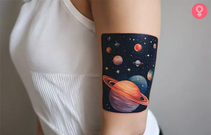 A woman with a vibrant space background tattoo design on her upper arm