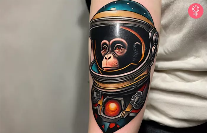 A woman with a vibrant space monkey tattoo design on her arm