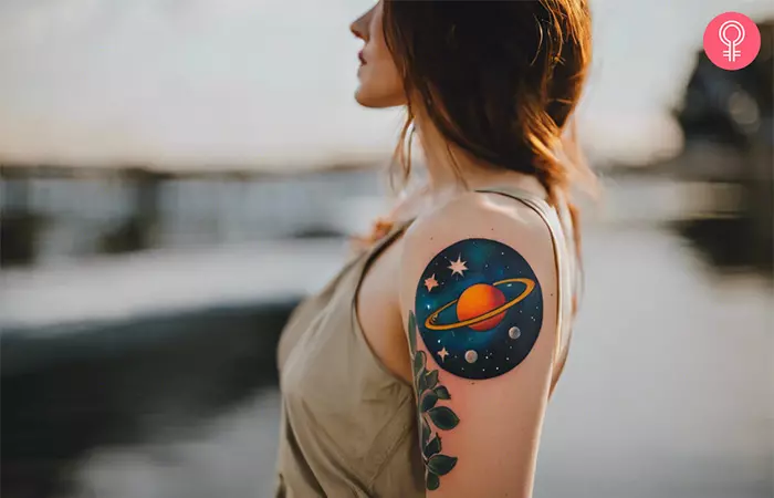 A woman with an outer space tattoo design on her upper arm