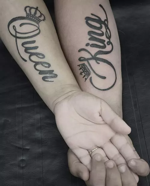 King and queen tattoos along with crowns on the forearms