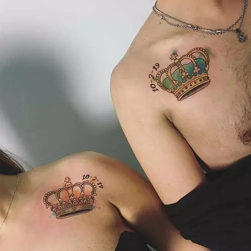 King and queen tattoos with crowns and dates below the collarbone