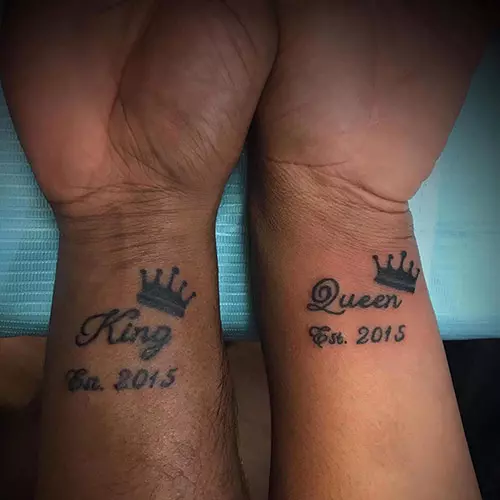 King and queen tattoos with crowns and dates on the wrist