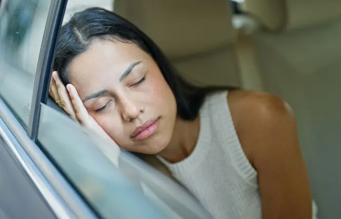 A woman sleeping in a cab