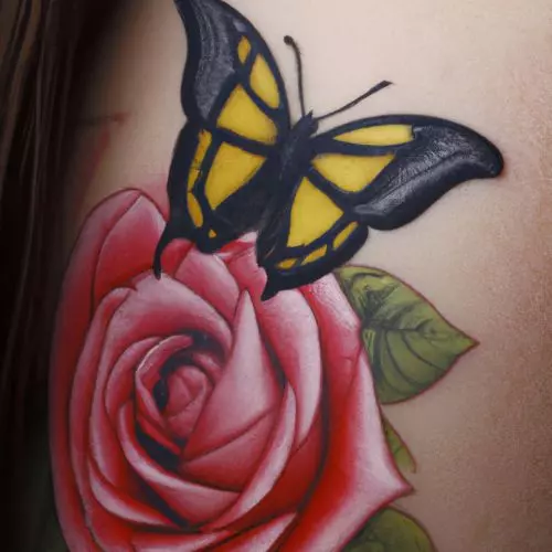 Rose and butterfly tattoo on the arm