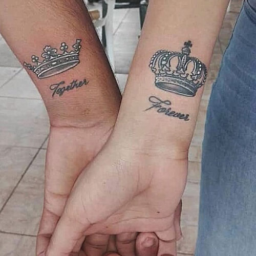 White ink king and queen crown tattoos on the wrists