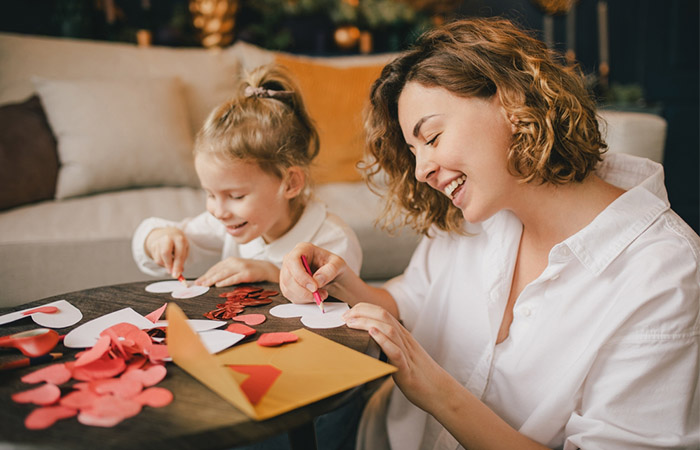 Mother and daughter making Valentine's Day cards