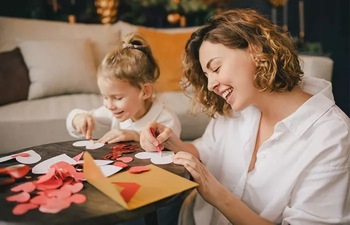 Mother and daughter making Valentine's Day cards